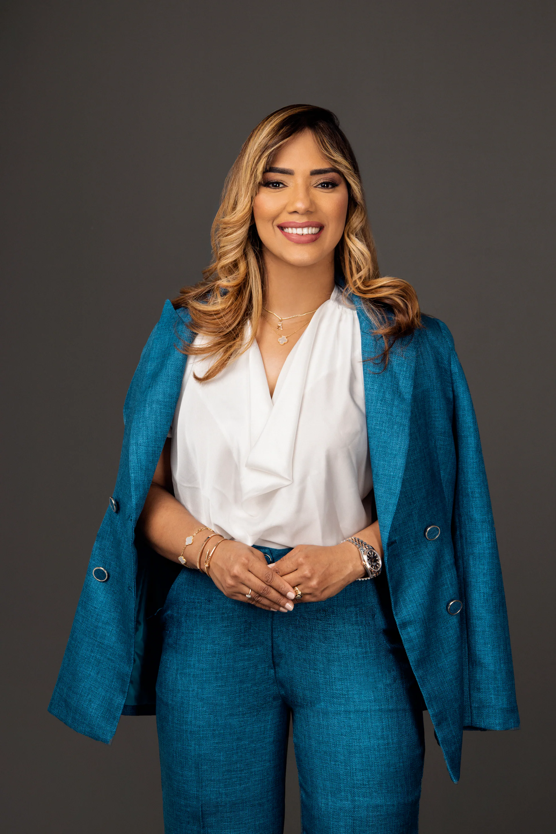 Professional portrait of Dr. Aurys Mercedes wearing a blue suit